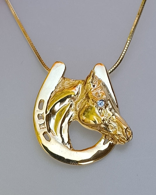 Horse in horseshoe  pendant with Peridot stone eye.  Artisan HEAVY gold plated.  Forge Hill Sculpture jewelry