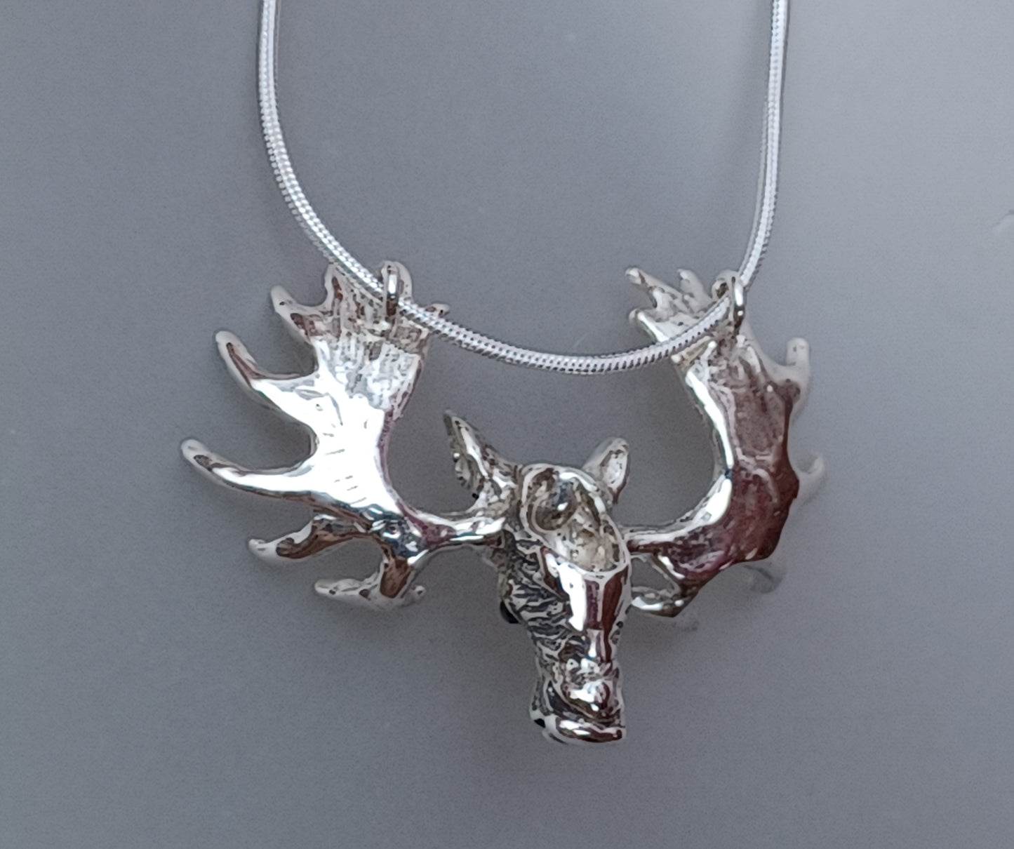 Moose Large pendant necklace. Sapphire stone set eyes.  Heavy Snake chain.  Sterling silver artist original. Impressive piece!