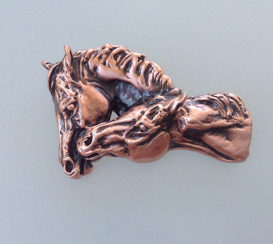 Copper finish nuzzling horses pewter pendant .  Authentic original design Zimmer