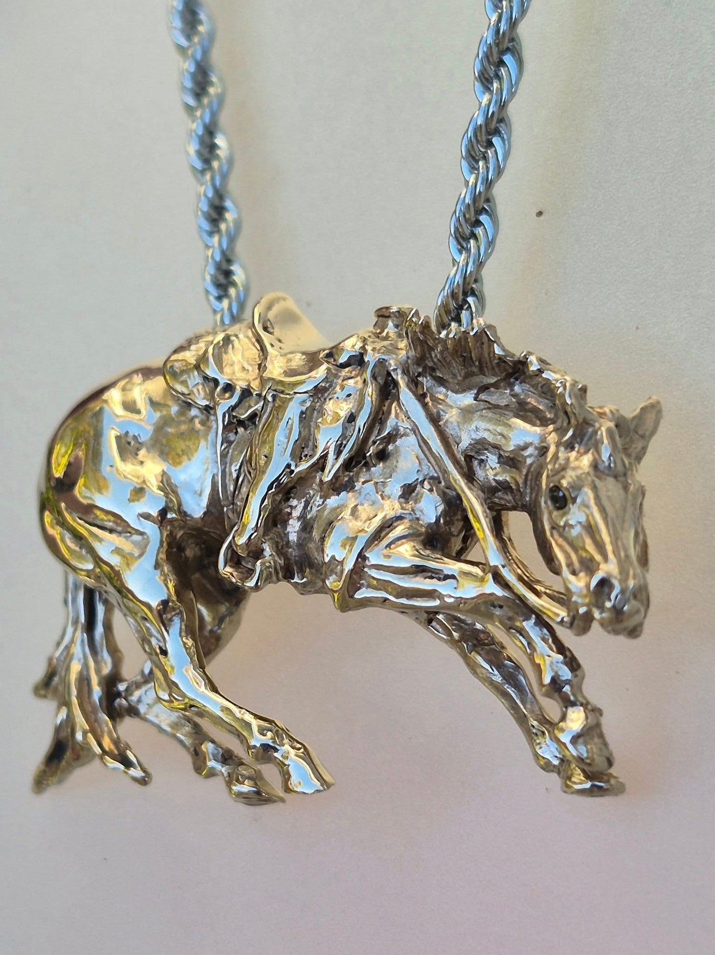 Cutting Horse with Western Saddle, stone set eyes cast in bronze, stainless steel chain