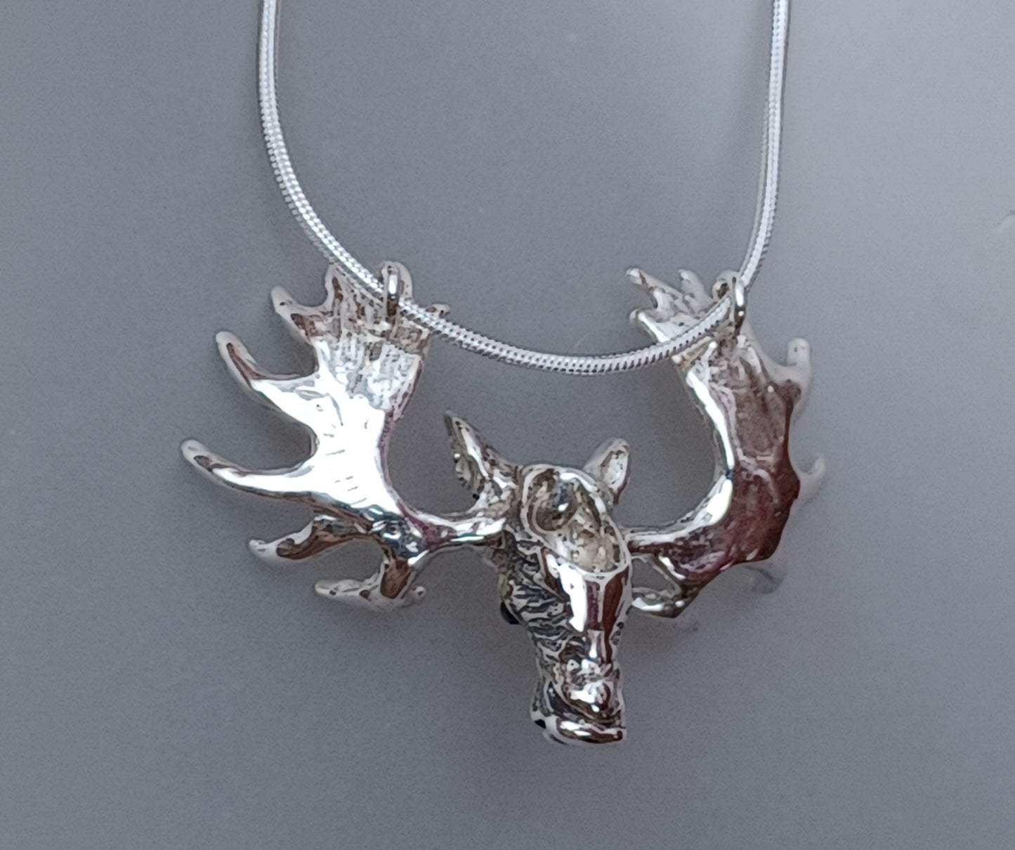 Moose Large pendant necklace. Sapphire stone set eyes.  Heavy Snake chain.  Sterling silver artist original. Impressive piece!