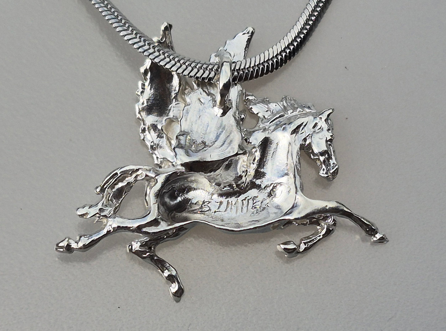 Pegasus Sterling silver pendant and stainless steel chain.